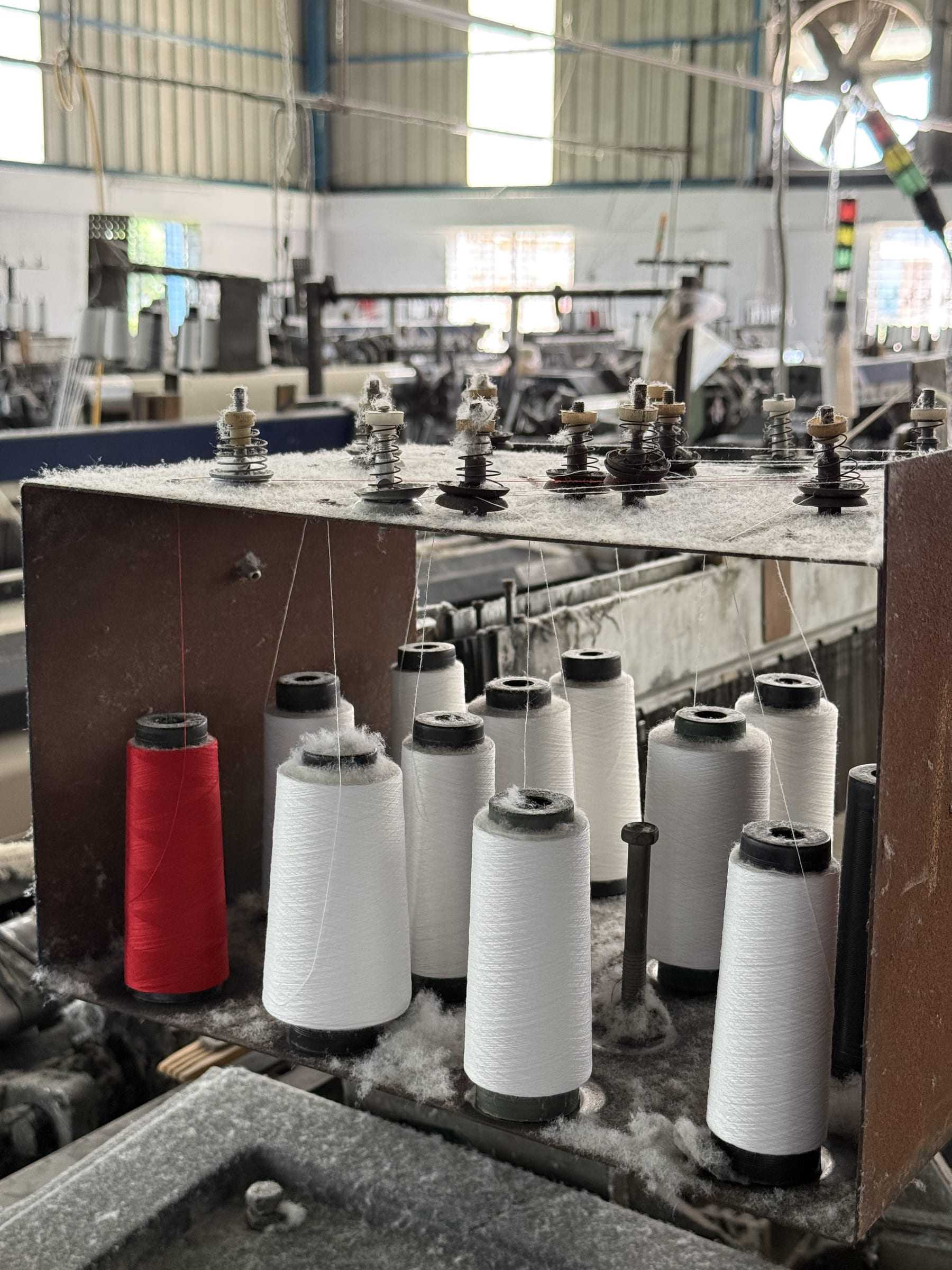 Cones of yarn at the Weaving Unit